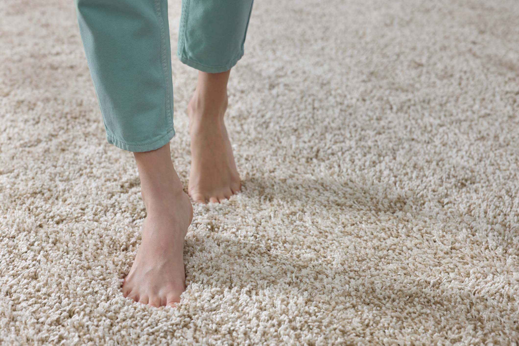 Bare feet walking on fresh, soft carpet, symbolizing the comfort and cleanliness provided by Safer Choice Cleaning’s toxin-free carpet cleaning in Southern California.