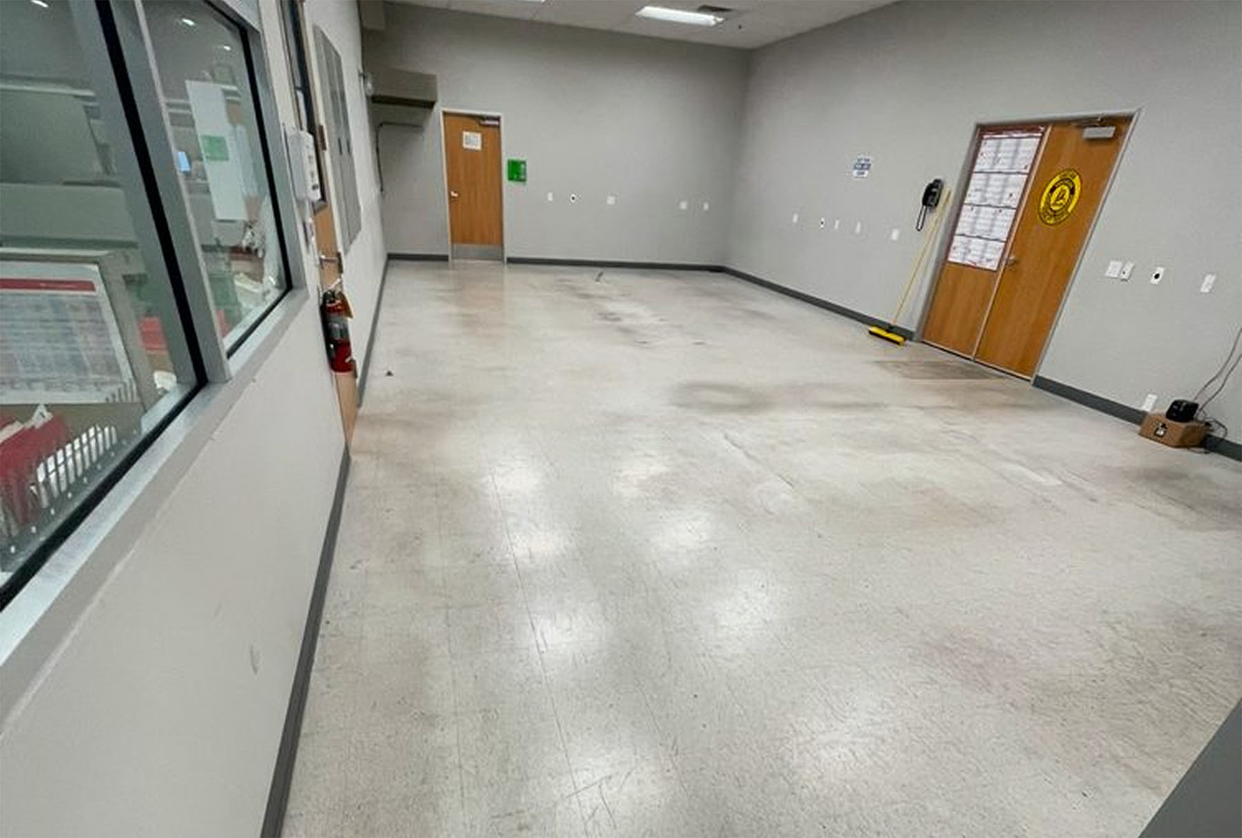 Worn and stained tile flooring in a high-traffic facility before deep tile and grout cleaning service in a Southern California business.