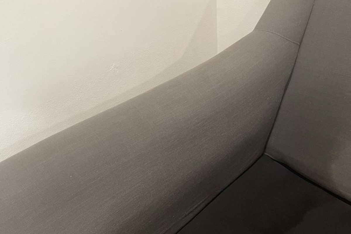 Clean dark-gray upholstered couch armrest — expert sofa upholstery restoration with non-toxic methods in San Bernardino County.
